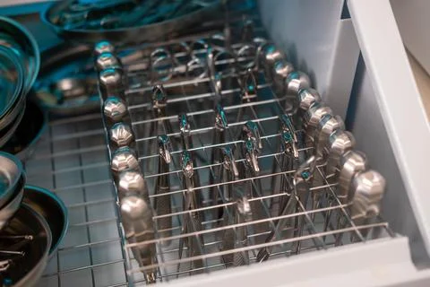 Dentist's instruments in the sterilizer. Various iron tools used in dentistry to Stock Photos