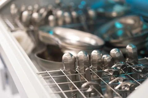 Dentist's instruments in the sterilizer. Various iron tools used in dentistry to Stock Photos