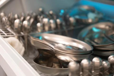 Dentist's instruments in the sterilizer. Various iron tools used in dentistry to Stock Photos