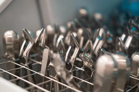 Dentist's instruments in the sterilizer. Various iron tools used in dentistry to Stock Photos