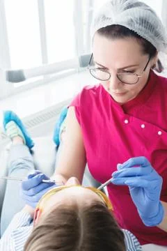 In the dentist's office. A female dentist in glasses is preparing to make a cast Stock Photos