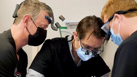 Dentists in professional equipments operating Stock-Footage 127000892
