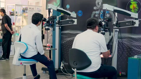 Dentists working with microscopes at a dental exhibition Stock Footage 310976996