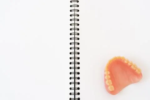 Denture on notebook background Stock-Fotos