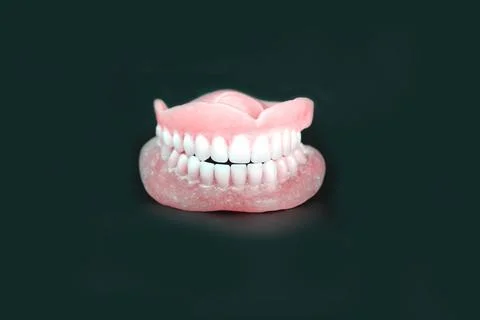 Denture of removeable on dark background. closeup image Stock Photos