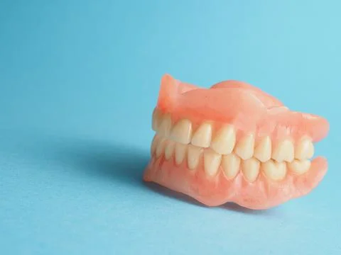 Dentures on a blue background Stock Photos