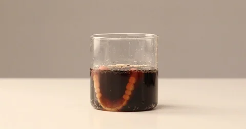 Dentures falling into glass of cola Stock Footage 97260540