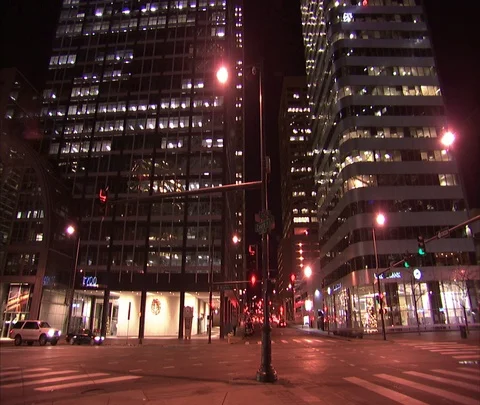 Denver, CO; MS Night time traffic passes skyscrapers at 17th and Court Streets Stock Footage 86748142