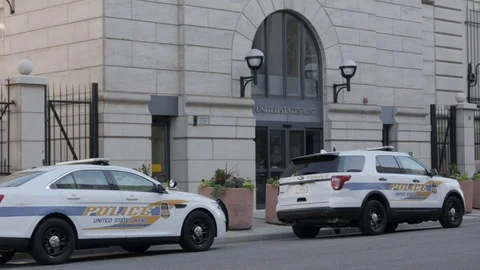 Denver US Mint Exterior Close Up on Police Cars with Passing Car Stock Footage 85197595