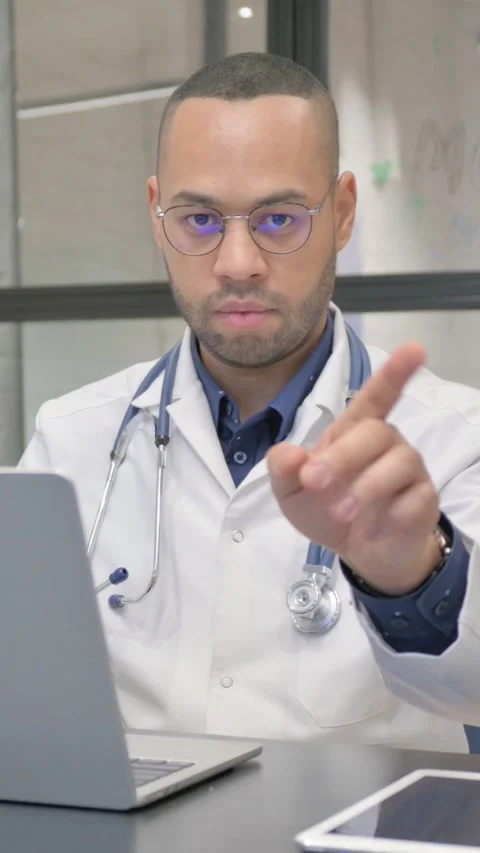 Denying Hispanic Doctor Restricting while Using Laptop, vertical video Stockbeeldmateriaal 325700942