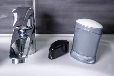 Deodorant in the bathroom with grey wall Stock Photos