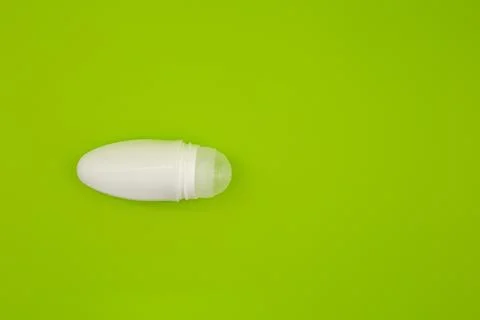 Deodorant on a bright green background Stock Photos