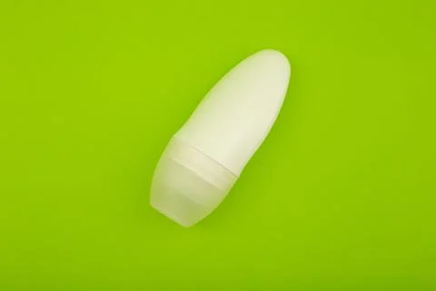 Deodorant on a bright green background Stock Photos