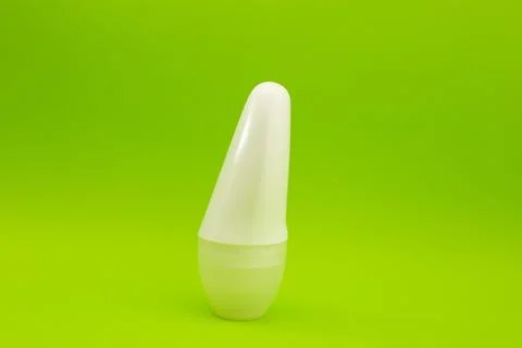 Deodorant on a bright green background Stock Photos