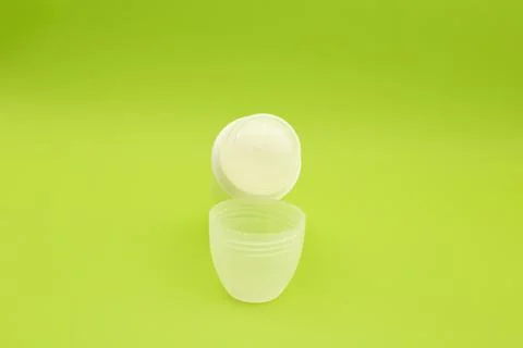 Deodorant on a bright green background Stock Photos