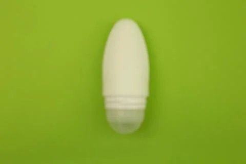 Deodorant on a bright green background Stock Photos