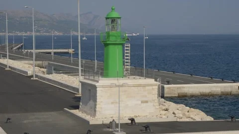 Departing Ferry and Split Panorama Behind Green Lighthouse Stock Footage 249118849