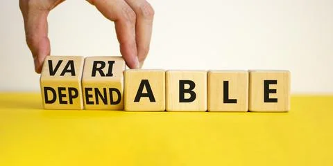 Dependable or variable symbol. Businessman turns wooden cubes and changes the 스톡 사진