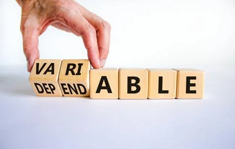 Dependable or variable symbol. Businessman turns wooden cubes and changes the Fotos de archivo