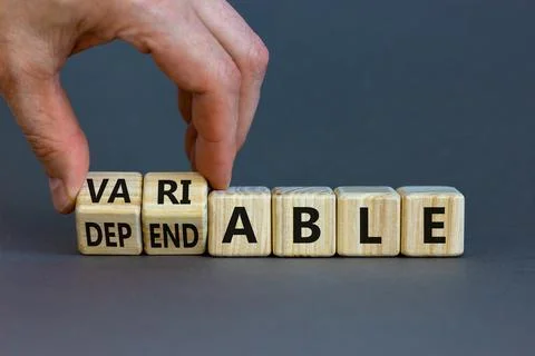 Dependable or variable symbol. Businessman turns wooden cubes and changes the 스톡 사진