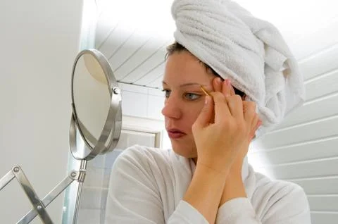 Depilating the eyebrow Stock Photos