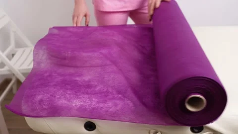 Depilation master covers couch with disposable sheet Stock Footage 147096251