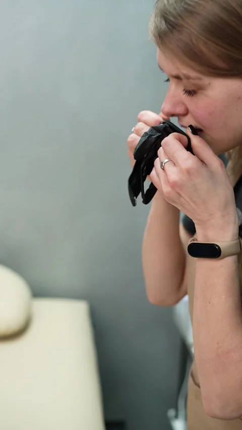 Depilation master puts on black protective gloves before the procedure Stock-Footage 264857616