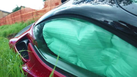 Deployed airbag inside the car at the moment of road accident, vehicle lost 動画素材 345439943