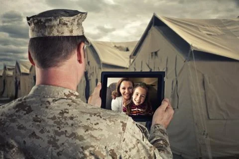 Deployed Military Man Chats With Family on Computer Stock Photos