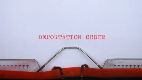 Deportation order - phrase printed on an old typewriter in red letters, close up Stock-Footage 128400029