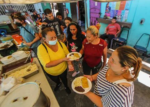 Deported Mexican gives 'warm food' to migrants at the border, Tijuana, Mexico -  Stock Photos