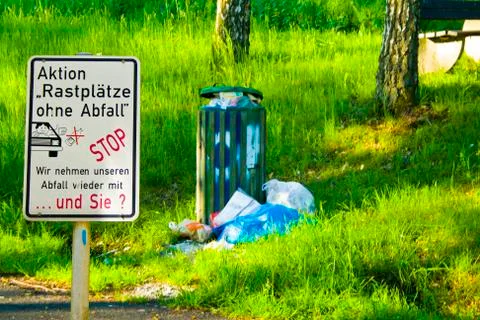 Deposed garbage at a rest stop in Hesse, Germany. With sign Stock Photos