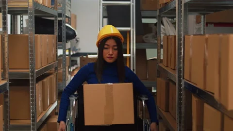 Depot employee with disability taking boxes off of racks Stock Footage 233745294