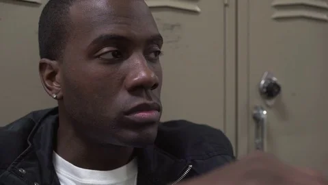 Depressed African American male in front of school locker 4k Stock Footage
