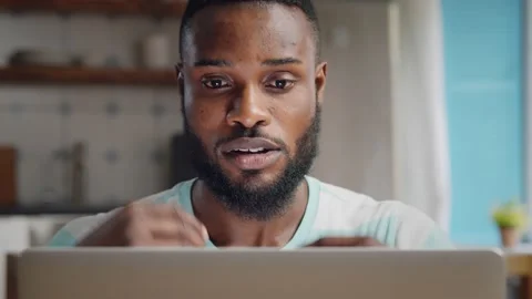 Depressed african businessman having problems with work sitting at home Stock Footage 133045478