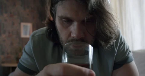Depressed alcoholic man not drinking whiskey, battling addiction. Alcoholism Stock Footage 245772042