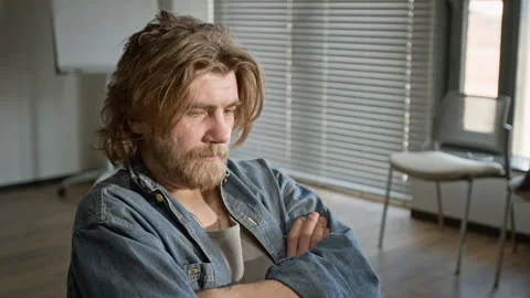Depressed Bearded Man Sitting in Support Group with Crossed Arms Stock Footage 337230512