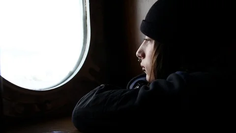 Depressed boy looking through window full view Stock Footage 82963280