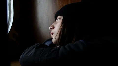 Depressed boy looks through window Stock Footage 82963195