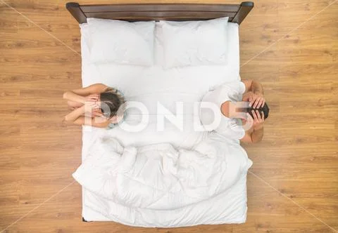 The depressed couple hold head on the bed. view from above Stock Photos