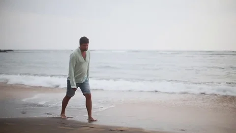 Depressed disappointed man going away by the sea shore. Desert island. Stock Footage 80423502