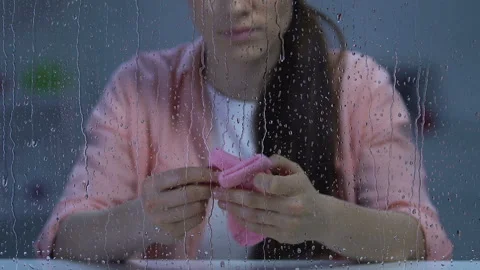 Depressed female holding tiny pink socks, obstetric violence victim, miscarriage Video stock 107573089