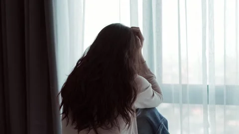 Depressed female sitting on a bed, feeling isolated and sad at home Stock Footage 344246108
