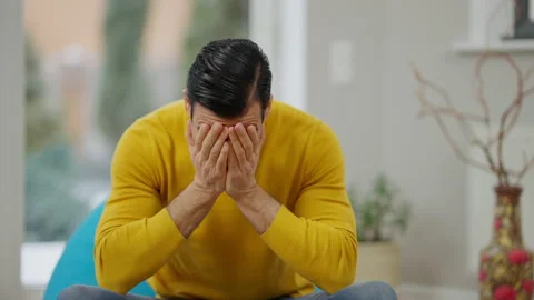 Depressed frustrated Middle Eastern man closing face with hands and shaking head Stock Footage 147466155