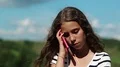Depressed girl talks on cell phone HD Footage