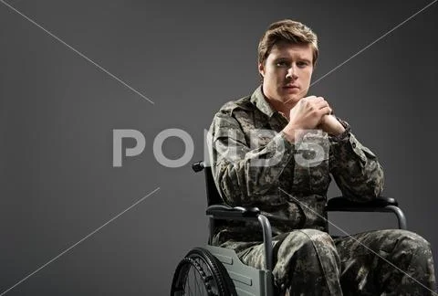 Depressed handicapped soldier feeling sorrow Stock Photos