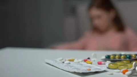 Depressed lady trying to commit suicide, pills and tablets on table, emergency 스톡 동영상 105077841