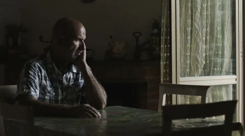 Depressed lonely man sitting at the table: sad man with problems, thoughtful 動画素材 42987453