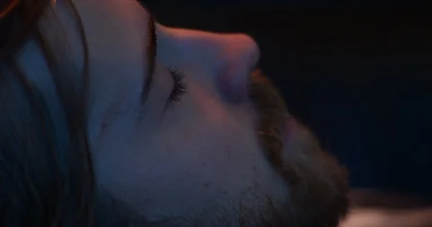 Depressed man in dark environment looking away Video stock 111387069