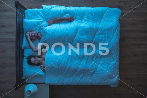 The depressed man lay near a woman. evening night time. view from above Stock Photos